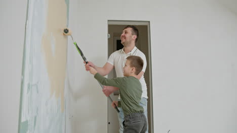 father and son painting a wall