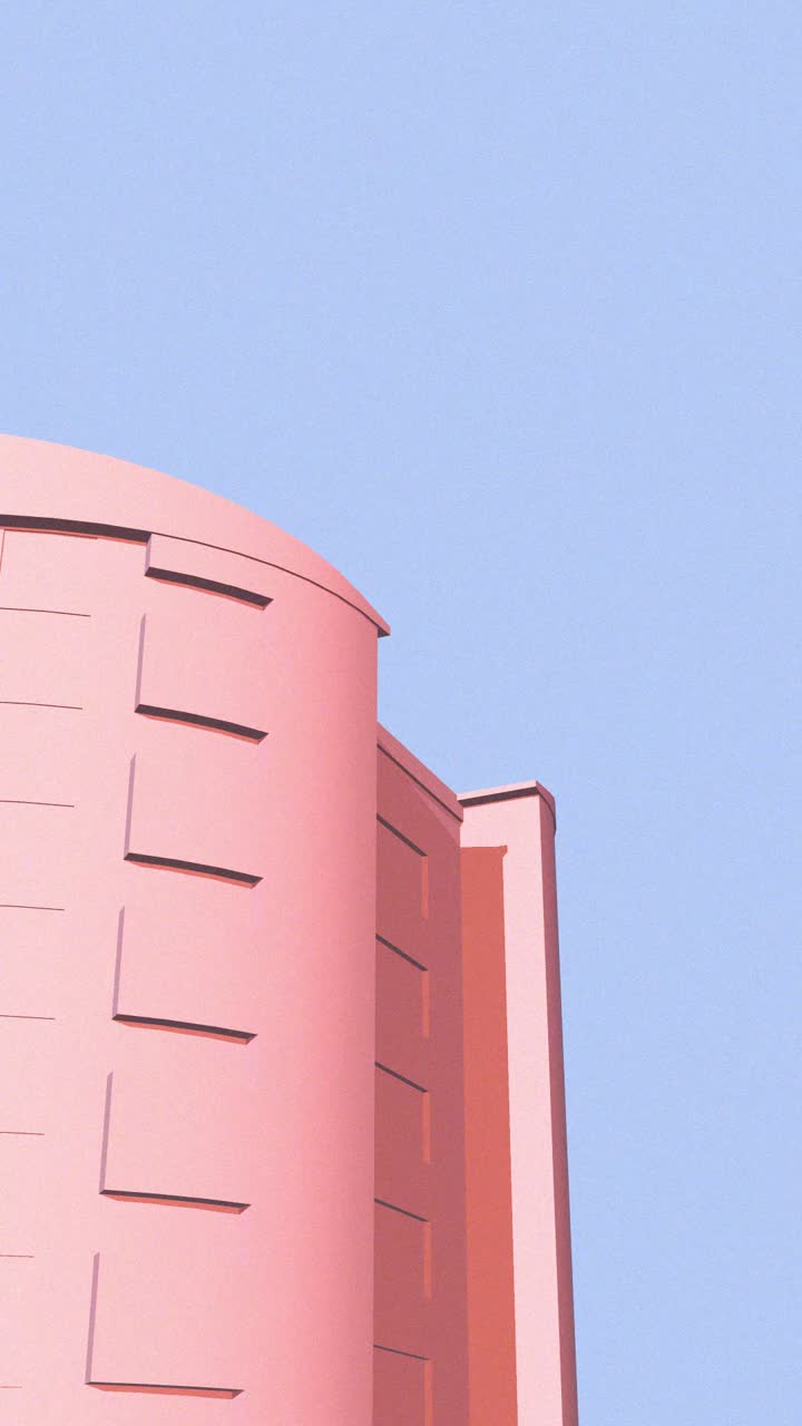 Panorâmica ascendente de um edifício rosa moderno com um céu azul ao fundo