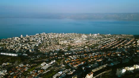 tiberias and the sea of ​​galilee in a very wide drone shot, at sunset