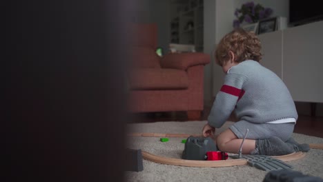 Little-boy-playing-with-toy-track