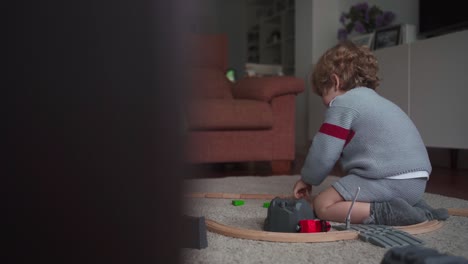 little boy playing with toy track