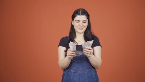 Woman-counting-money-looking-at-camera.