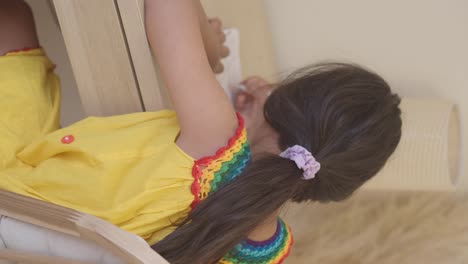 a girl with a ponytail wearing a yellow dress