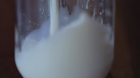 closeup shot, milk getting poured in glass