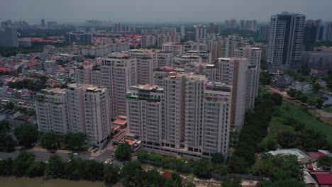 Aerial-suburban-view-on-sunny-day-with-large-apartment-and-housing-development-on-river-4