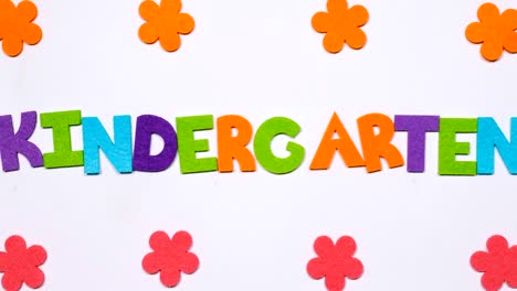 the word kindergarten is written in dancing letters of the colored alphabet.