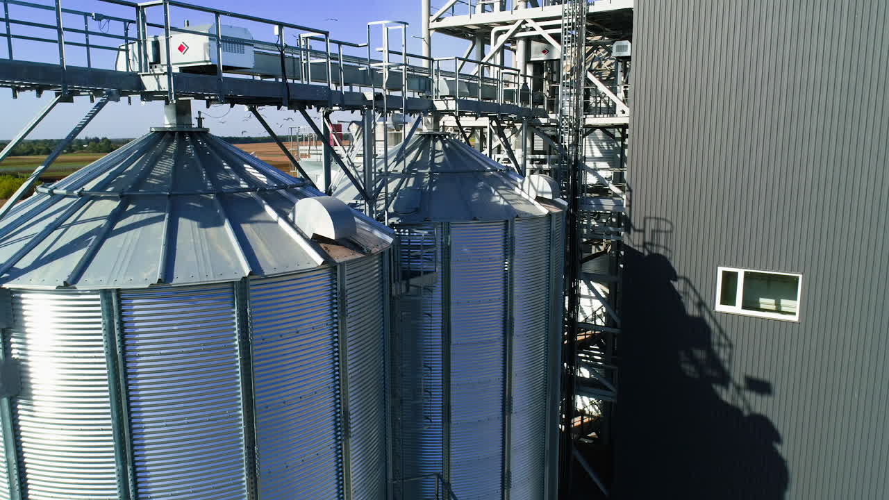 Grain elevator. Metal grain elevator in agricultural zone. Aerial view.