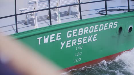 the back of a boat with the name of the boat in dutch on it in slowmotion