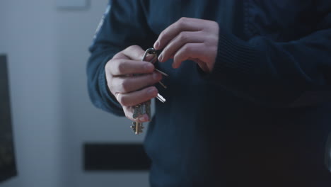 close-up of a person's hands holding a set of keys