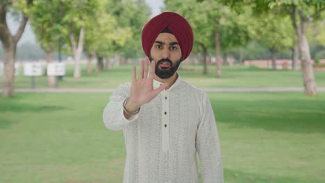 sikh indian man stopping someone in park