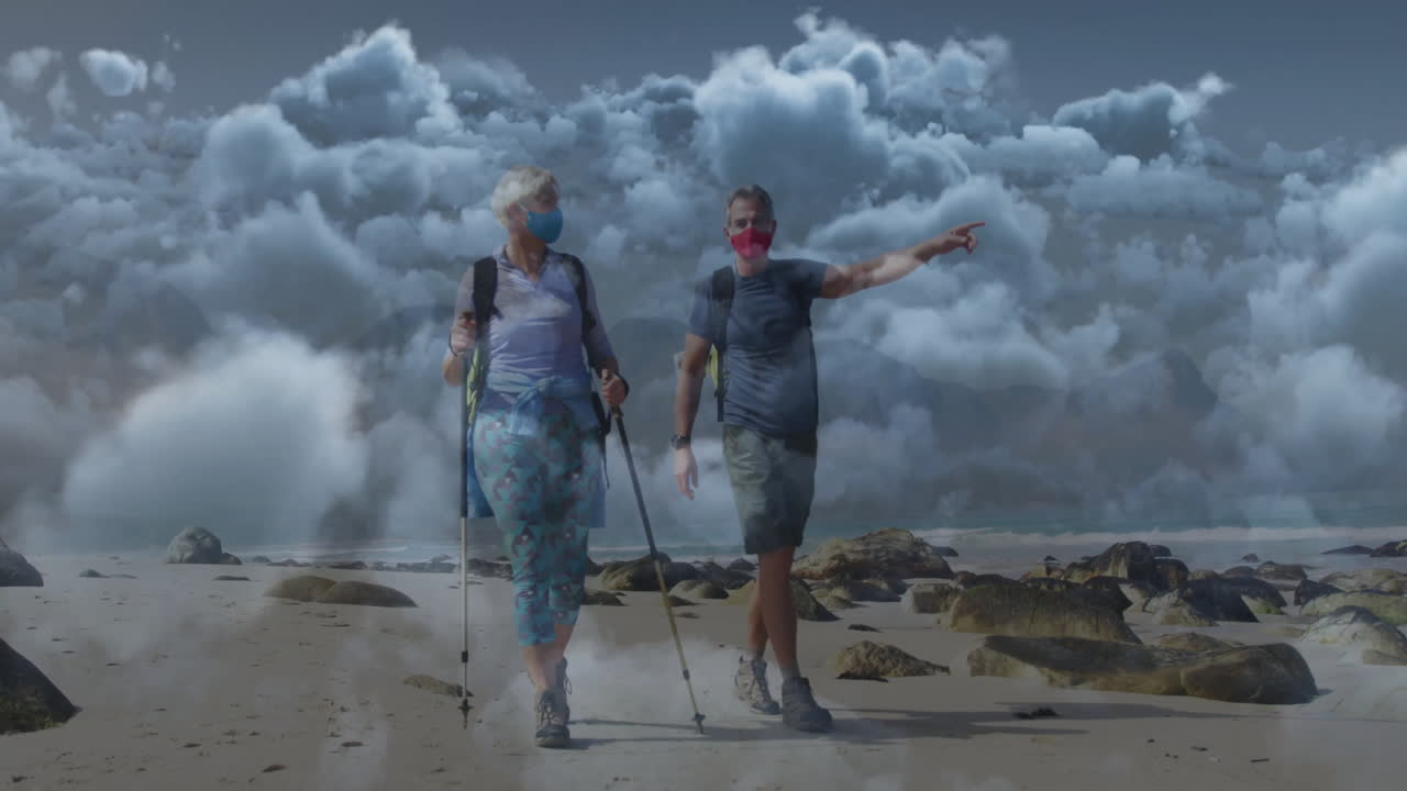 mature couple hiking on rocky beach, with animated route line and weather icon for health content