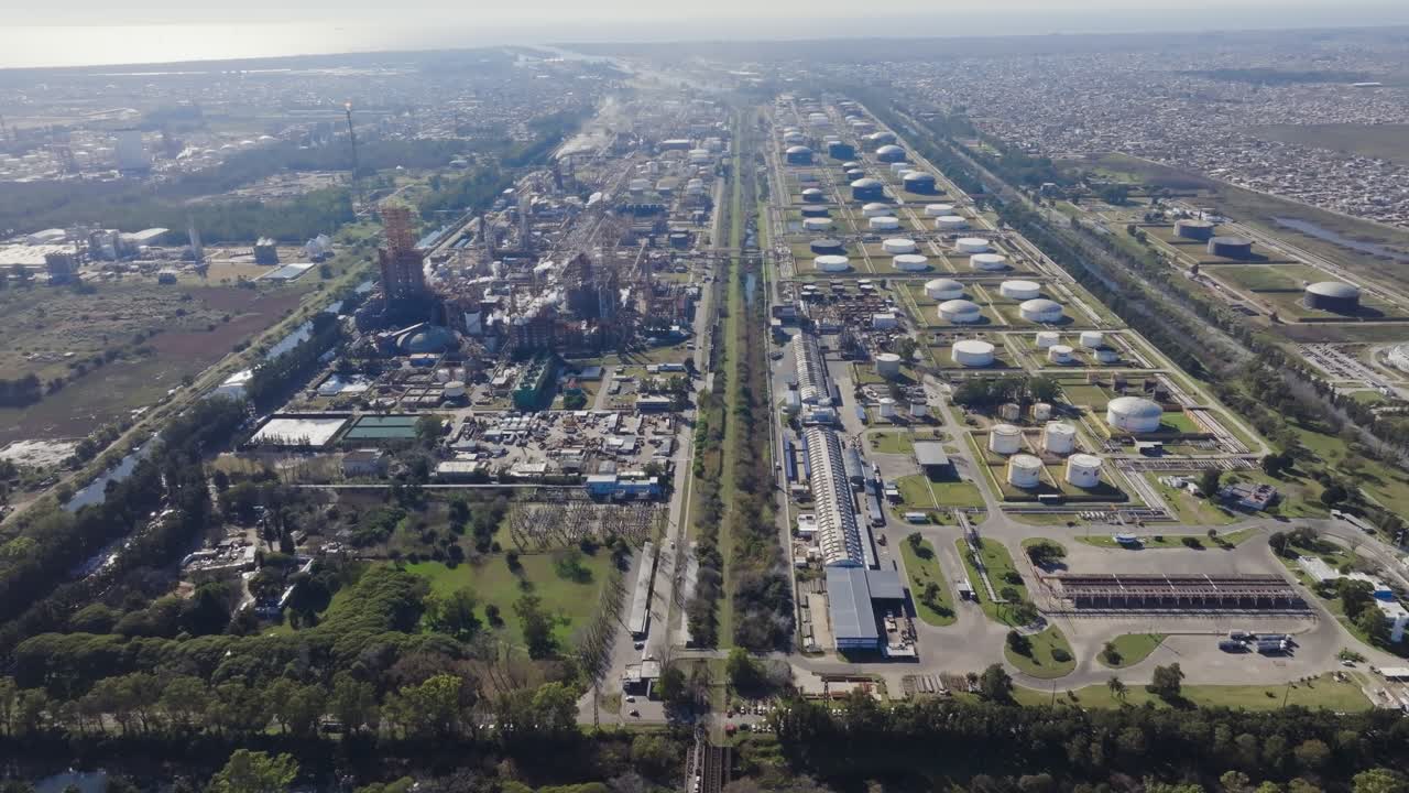 Drone footage of oil refinery in Argentina with suburban neighborhood around