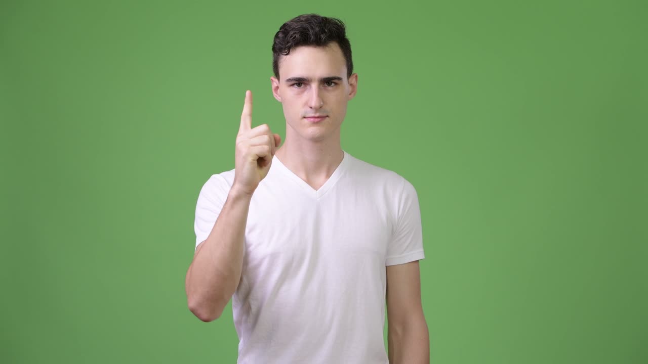 Young handsome man pointing finger up