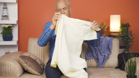 old man trying on clothes at home.