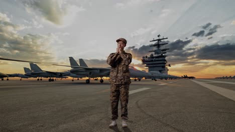full body of asian man army soldier uniform praying on aircraft carrier