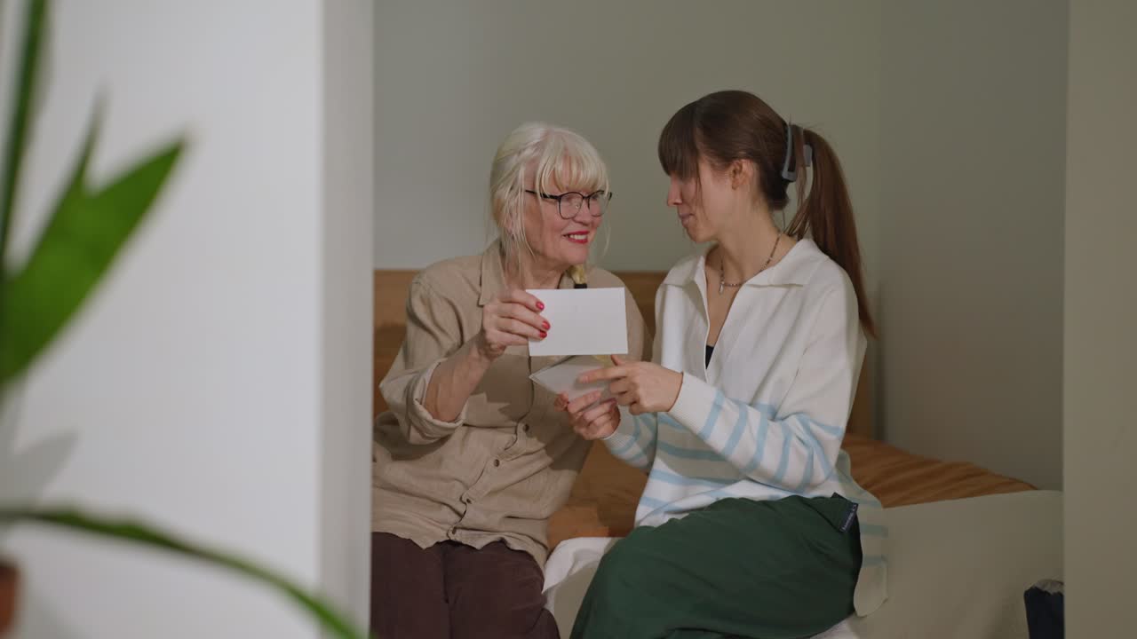 Grandmother and Grandchild Looking at a Picture Together