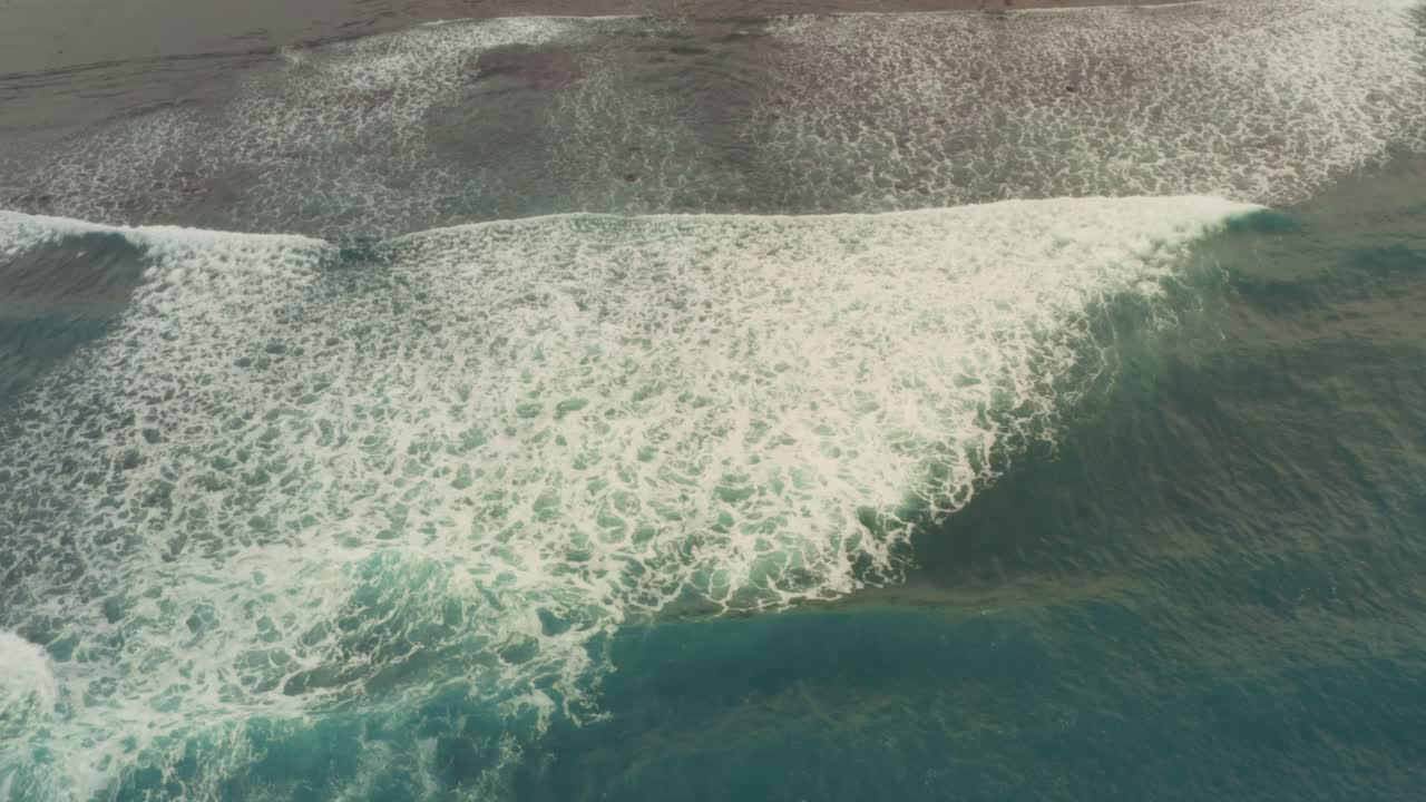 Aerial View of Ocean Waves Crashing on the Beach