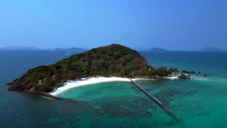 koh kham island with crystal clear turquoise water, white sand beaches and lush tropical vegetation, a popular tourist destination in thailand. dramatic aerial view flight static tripod hovering drone