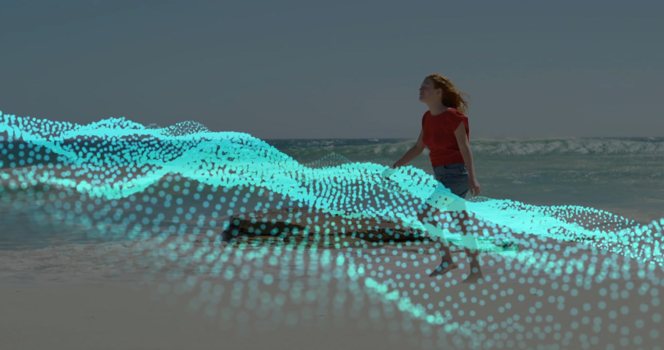 Vertical video: Woman walking along beach, activating teal dot wave overlay, showing tech UX demo