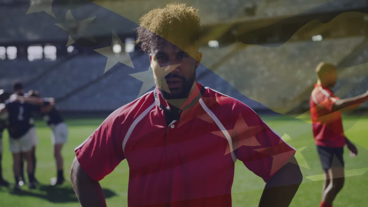 Rugby player in red jersey standing confidently with American flag animation