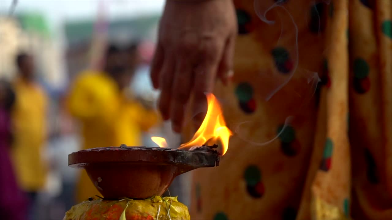 Chath Pooja Diwali Indian Festival Close up of Diya Flame people in background. USP