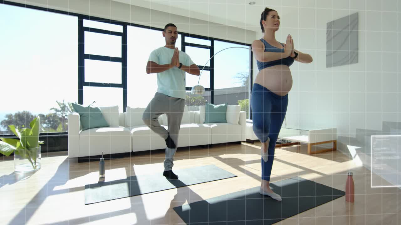 Couple doing prenatal yoga, woman leaving tree pose partner aiding belly rebalancing HUD overlaying