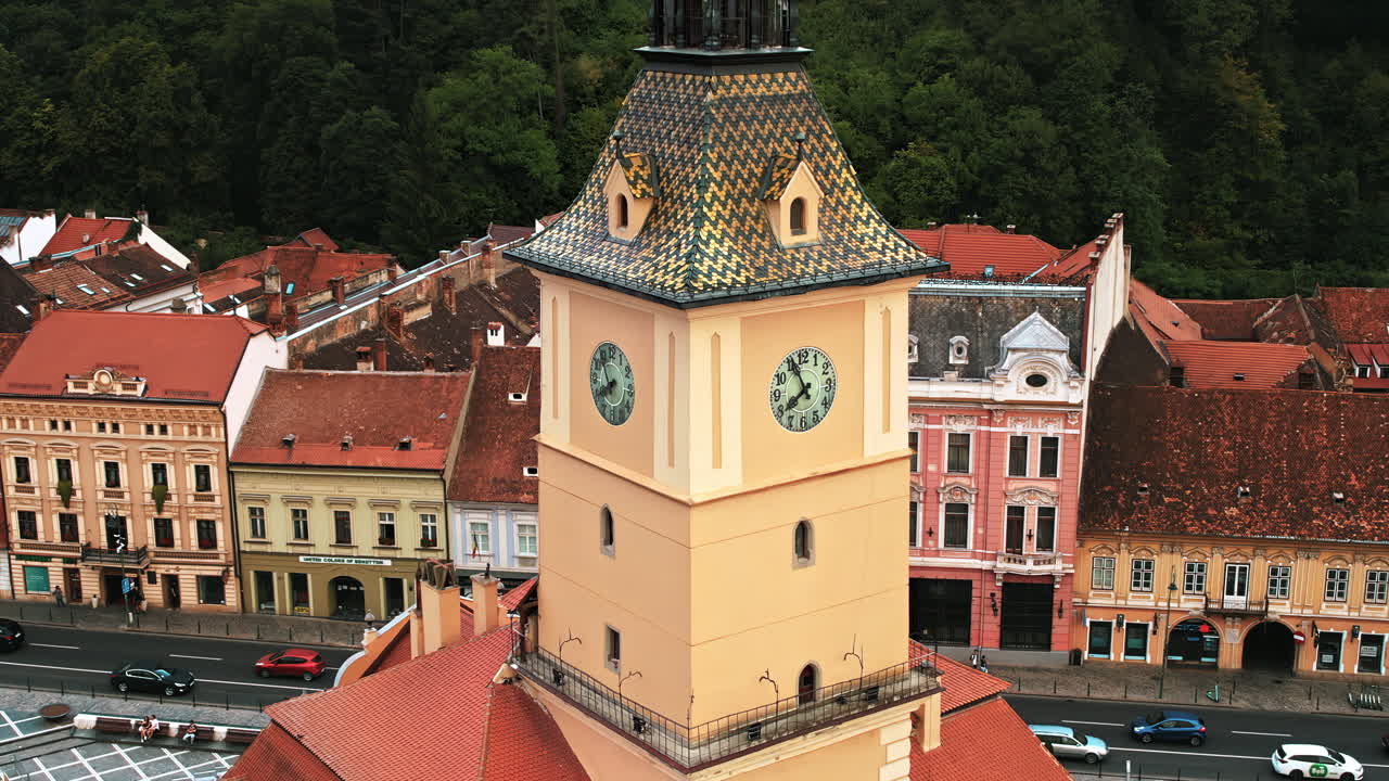 Aerial drone view of the County Museum of History at The Council Square in Brasov, Romania. Old buildings with moving cars around