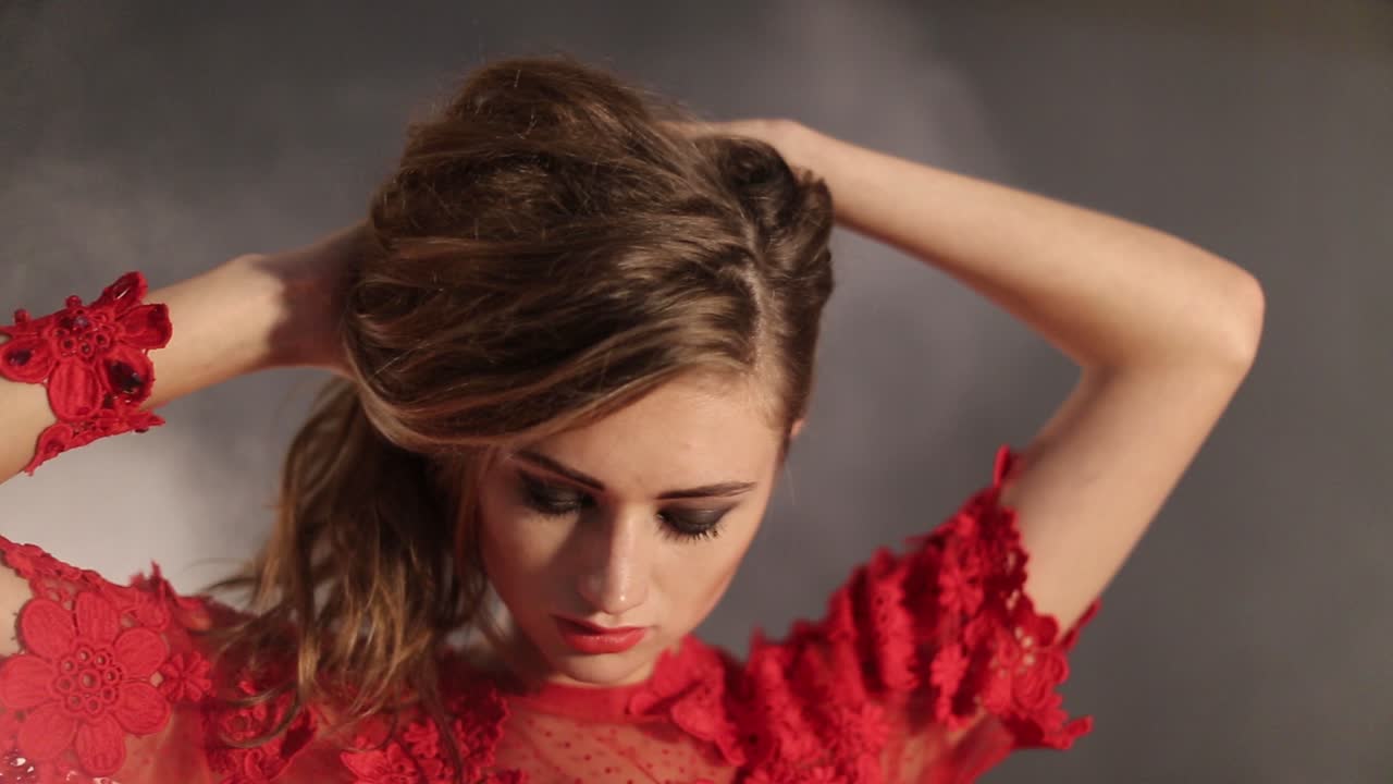 Young Woman Posing In Fog. Young woman in long red dress posing in fog