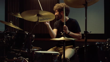 energic drummer playing on drum set