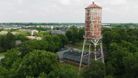 establishing aerial of old water tower rising in fort harrison park in lawrence