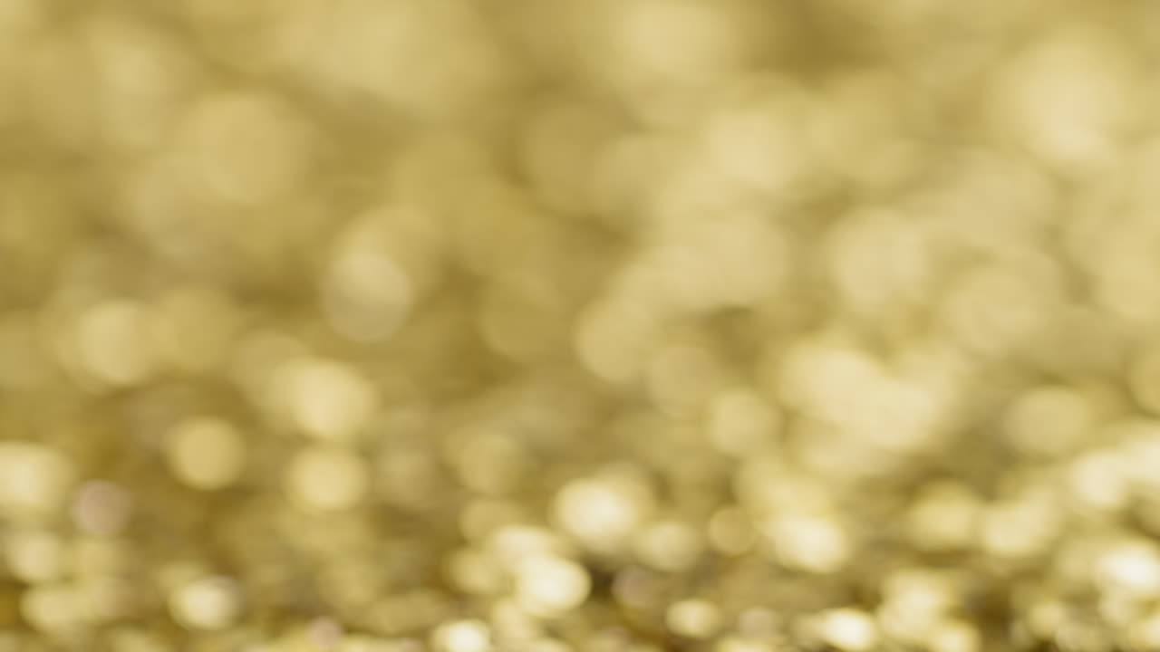 Gold sequins with blurred background, establishing background shot