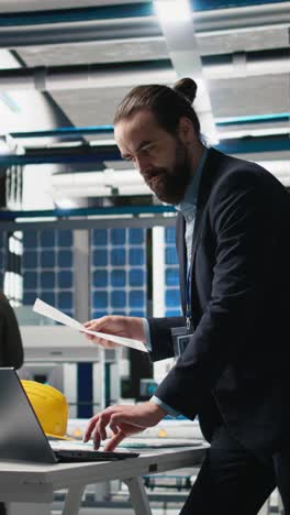 vertical video executive consultant oversees solar energy systems in industrial workplace