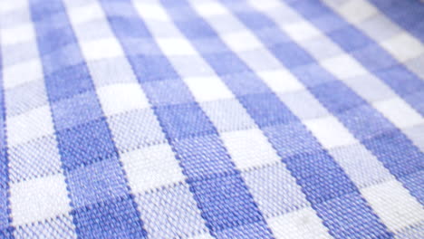 close up slide over blue and white checkered fabric