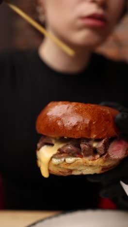 woman preparing a delicious gourmet burger