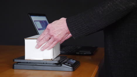 Weighing,-packing-and-shipping-an-item-sold-online-in-a-cardboard-box-with-bubble-wrap-to-a-customer-from-an-auction-ecommerce-website