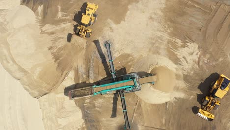 Aerial-view-loading-bulldozer-in-open-air-quarry