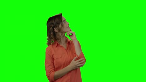 Smiling-woman-looking-around-against-green-screen