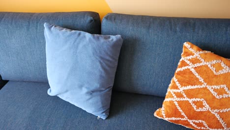 close-up of a blue couch with pillows