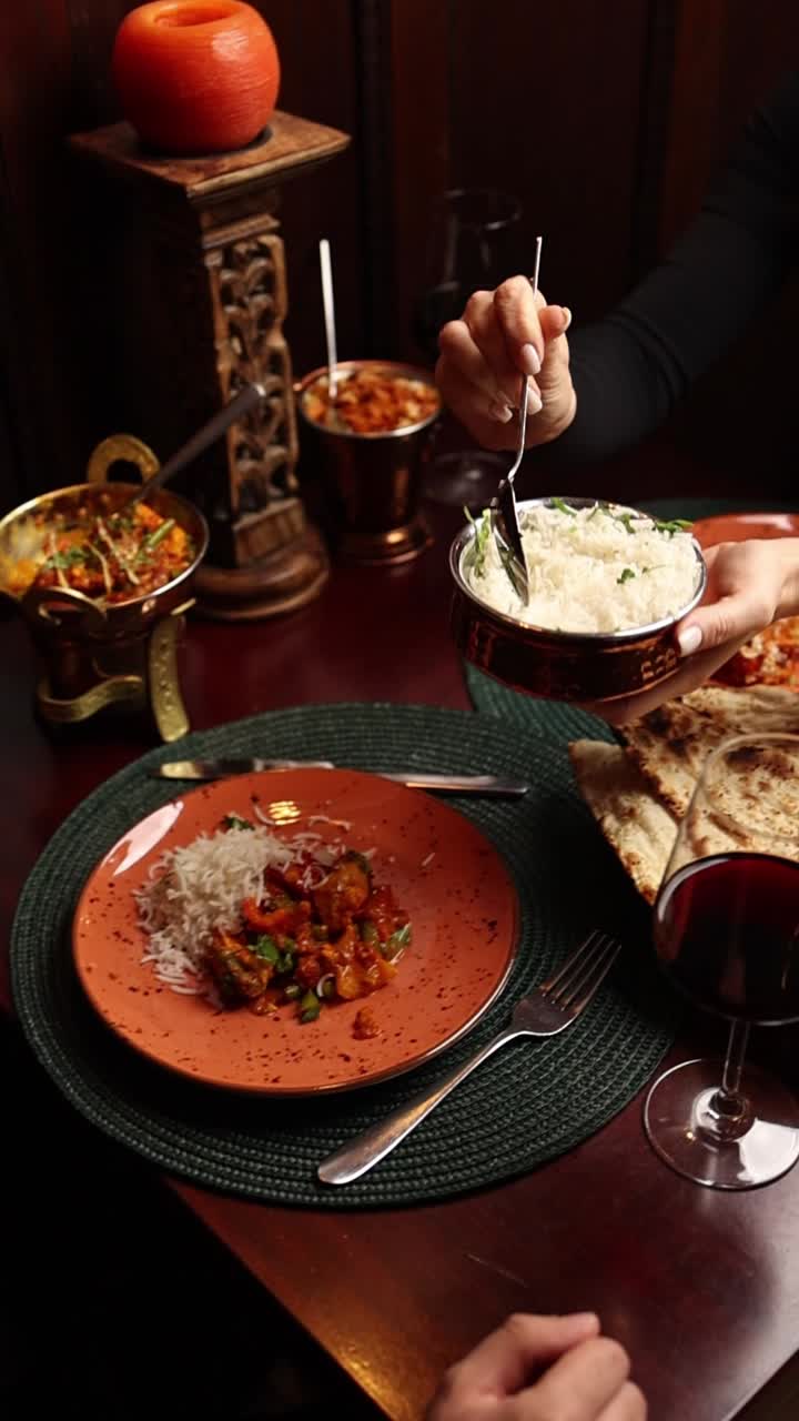 A delicious Indian dinner with rice, curry, and naan