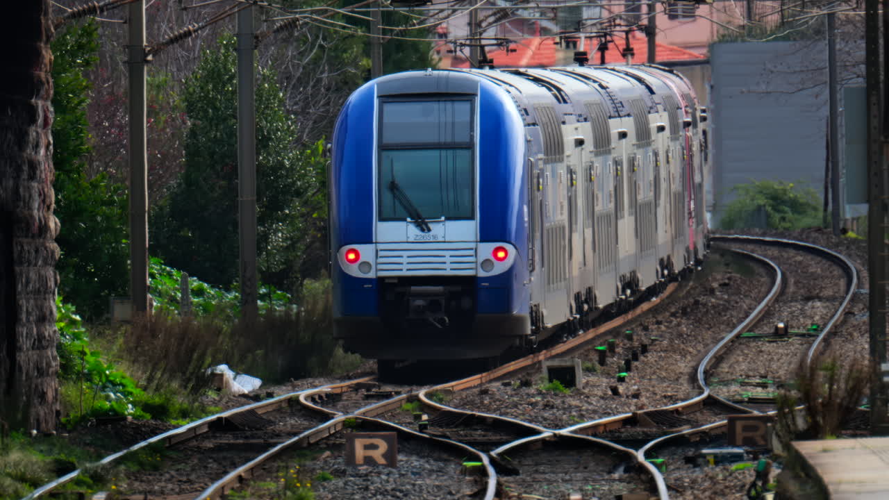 Cannes, France - February 4, 2025: Trains moving on the rails near a train station
