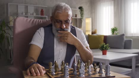 Senior-Man-Playing-Chess-At-Home-Alone.