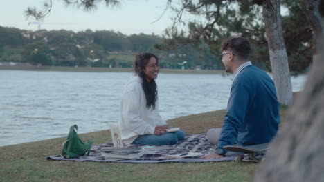 college friends sitting in the park and talking