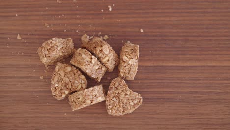 heart-shaped granola bites on wooden board