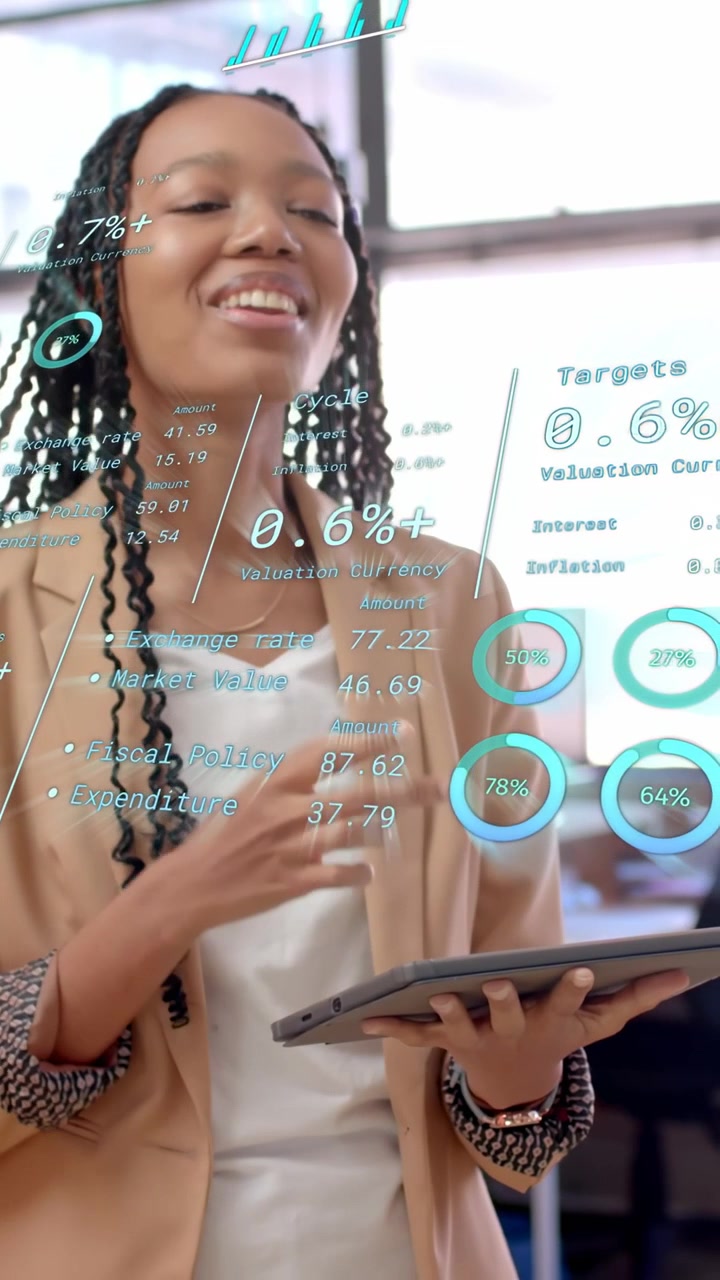 Vertical video: Woman analyst tapping tablet in office updating AR finance charts and showing data