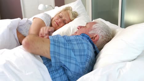 senior couple sleeping in bed