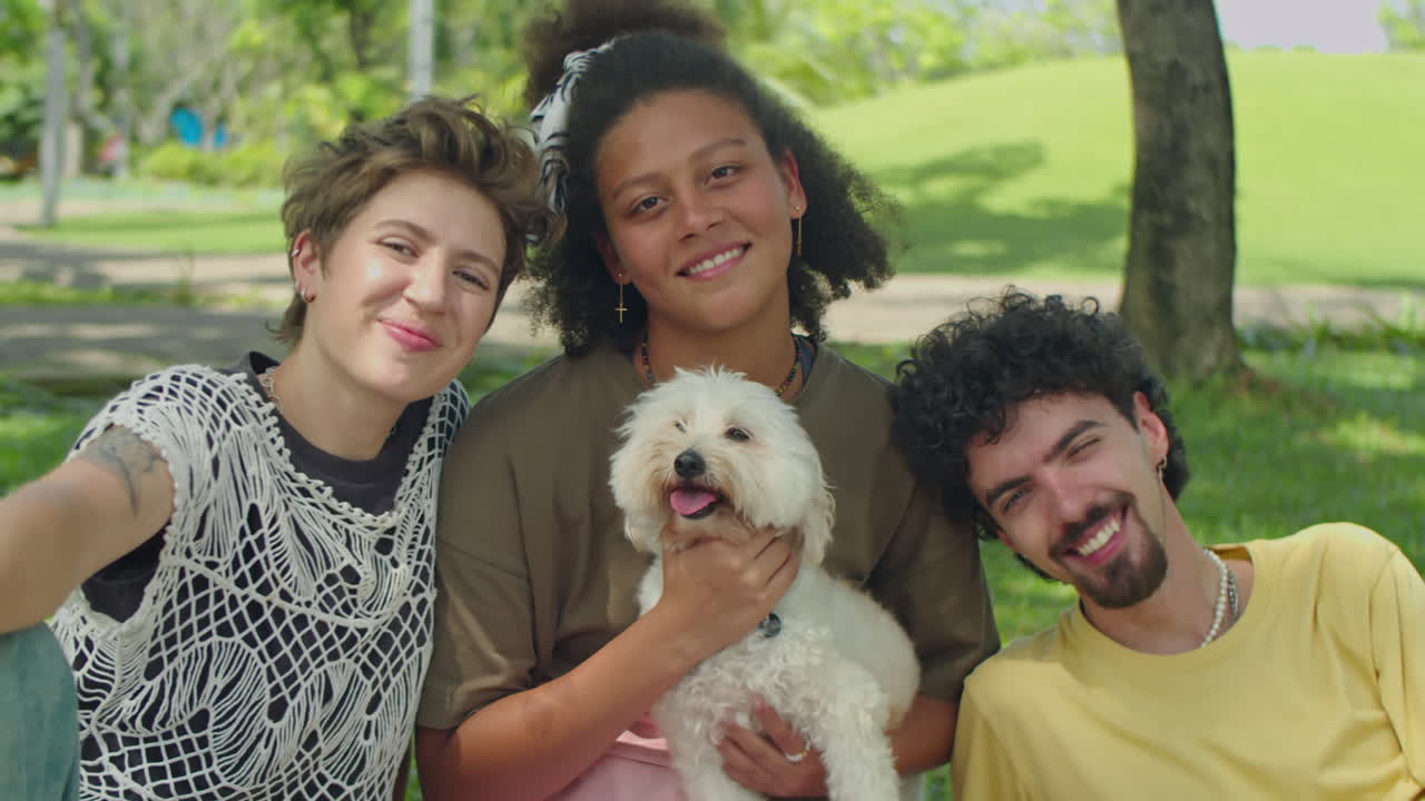 Portrait of Smiling Friends with Cute Dog in Park