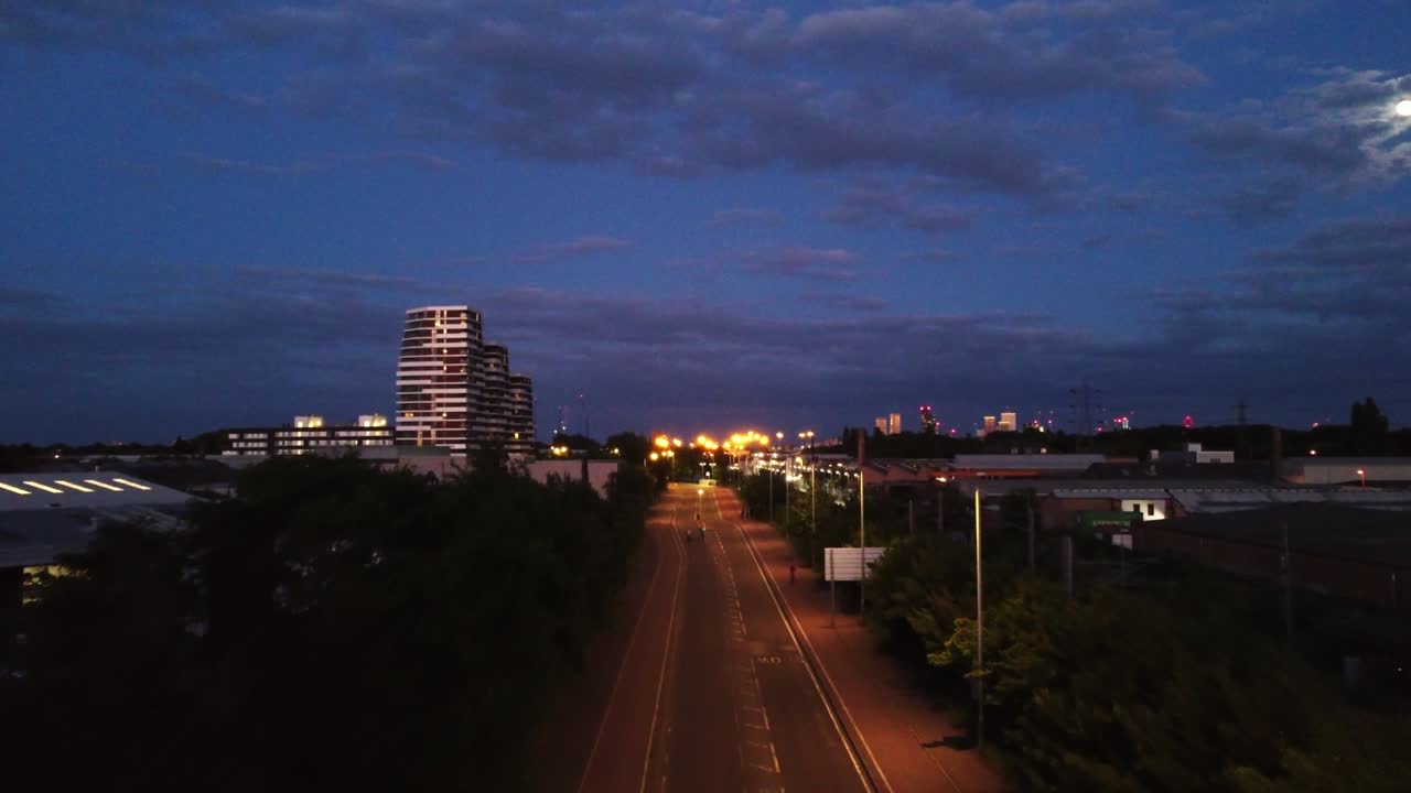 Drone shot flying over an empty road at night in London, England