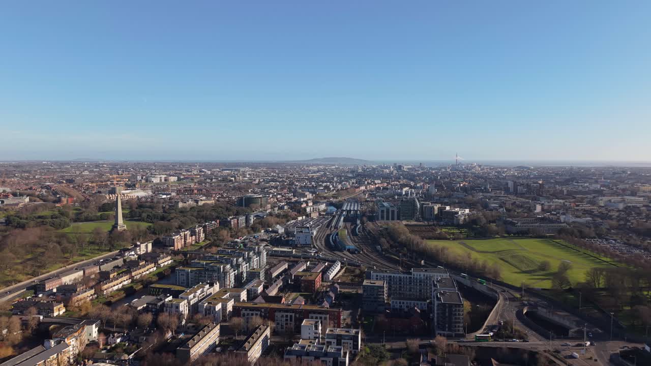 Dublin city skyline with Heuston train station, green parks, and a clear blue sky