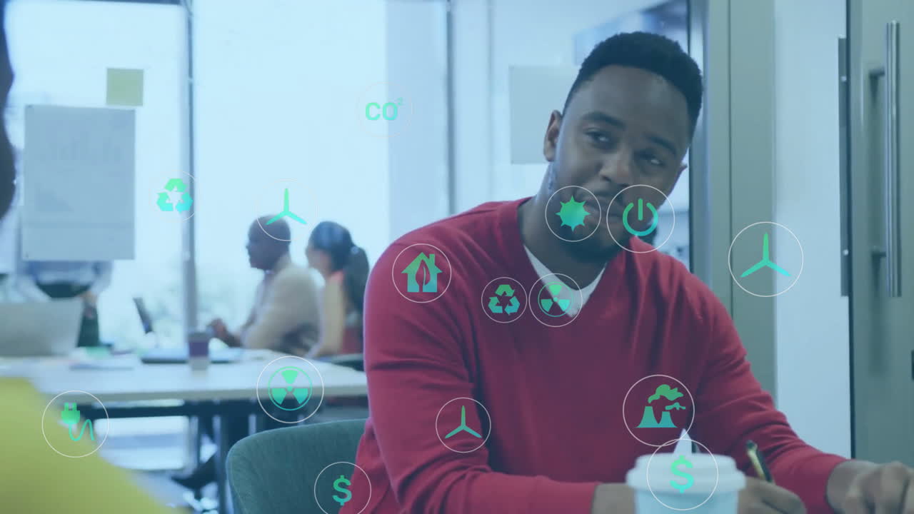 Animation of icon in circles over african american coworkers discussing on desk in office