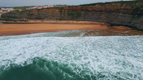 aerial view rippling ocean waves washing beach. sea surf covering empty seashore